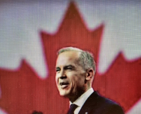 Picture of Mark Carney in front of Canadian Flag